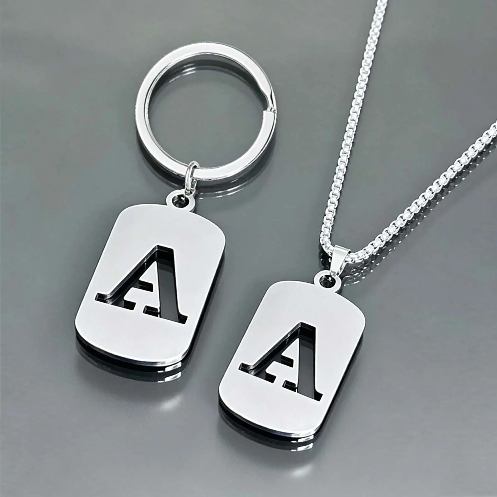 26-letter keychain necklace set, stainless steel hollow design, fashionable men's and women's couple gift, backpack charm.