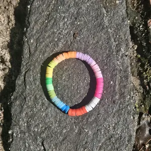 Clay Bead Bracelet - Colorful Rainbow Design on Stone Surface