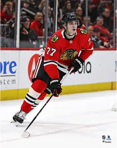 Kirby Dach Chicago Blackhawks Unsigned Red Jersey Skating Photograph