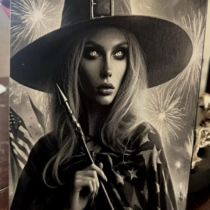 Beautiful spray-painted, laser-engraved canvas featuring a 4th of July witch that glows in the dark