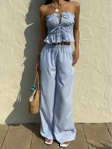 2 piece women's suit with a striped pleated waist top and trousers