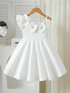 Toddler girls’ 3D flower party dress, ages 4–7 years. Chic asymmetrical one-shoulder design. Stunning white dress for birthdays, Mother’s Day brunch, and church. Pearl details and flared skirt—the perfect gift for your little princess.