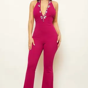 RHINESTONE DETAILED HALTER TOP JUMPSUIT DEEP V-NECK OPEN BACK BUTTON CLOSURE ON BACK NECK ZIPPER CLOURE ON BACK PANTS BELL BOTTOM MODERATE STERETCH MODEL: 5'8" SMALL SELF: 95% POLYESTER 5% SPANDEX, LINING: 100% POLYESTER