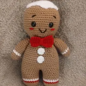 Crochet Gingerbread Man Plushy with Red Bow Tie and White Trim Festive Christmas Toy