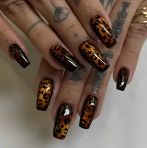Edgy leopard print press-on nails featuring unique 3D water drop effects. Long coffin fake nails that elongate your fingers. Premium custom design, easy to apply at home, and perfect for parties or events