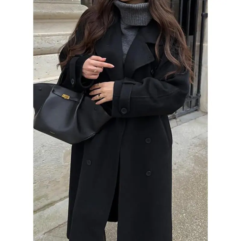 Black coat styled with knitwear