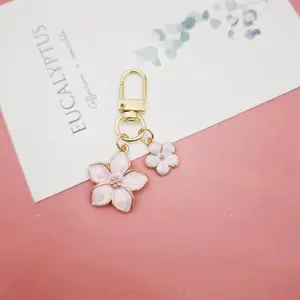 Elegant Pink Flower Keychain with Gold Trim and Double Floral Charm for Personalized Accessory