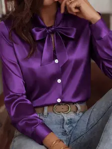 Classic long-sleeved satin shirt, blouse with a ribbon detail at the neckline. Elegant solid color, perfect for spring and summer wear. A stylish women's top.