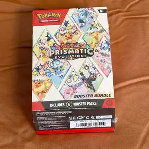 Pokémon Prismatic Evolutions Booster Bundle Includes 6 Packs Trading Card Game for Collectors