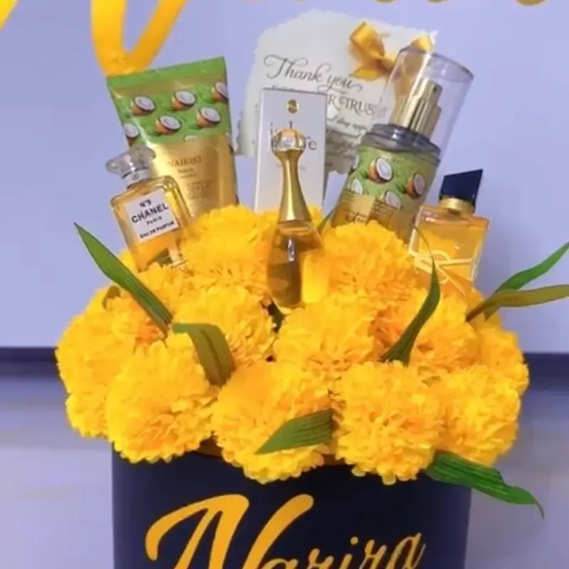 Narira Gift Flowers with Yellow Blossoms and Assorted Products in a Decorative Box