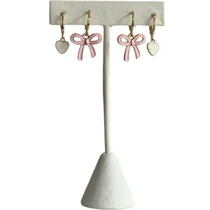 Take a Bow Earring Stack, bow huggie hoop earrings stacked with our neon white baby heart huggie hoop earrings