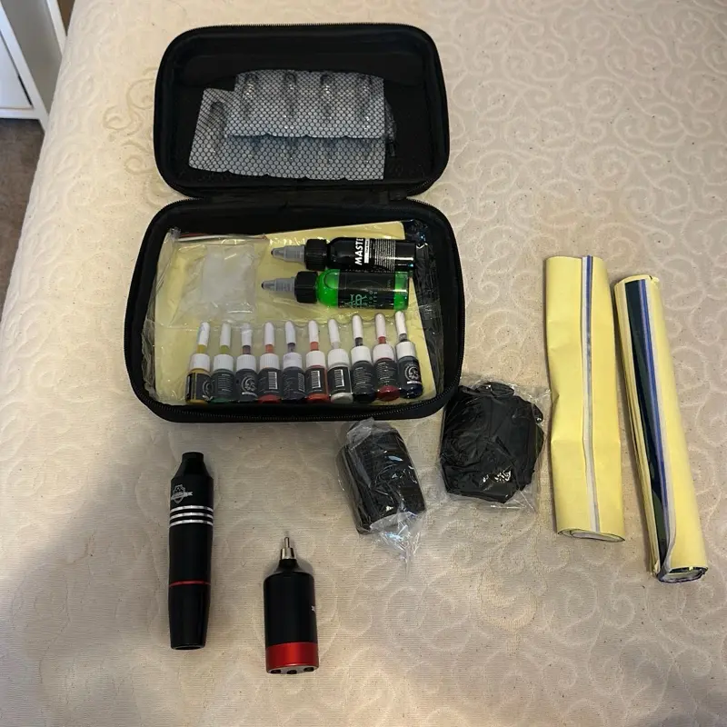 Tattoo Gun with Accessories including Black Case, Ink Bottles, and Yellow Roll - Product Description Not Provided