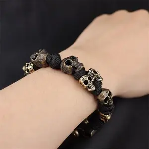 Men's Adjustable Skeleton Paracord Bracelet with Vintage Bone Charm - Gothic Braided Survival Wristband for Halloween Parties and Outdoor Adventures