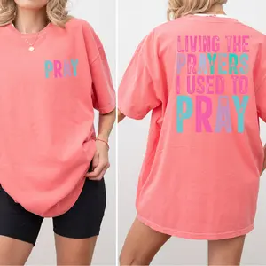 Christian Comfort Colors® God is Good Faith & Bible Verse Tee Long Sleeve Unisex Crewneck Sweatshirt Living the Prayers I Used to Pray Design Classic Fit 100% Cotton for Layered Streetwear Outfits Gildan 18000 Eco-Friendly Printing Made in USA