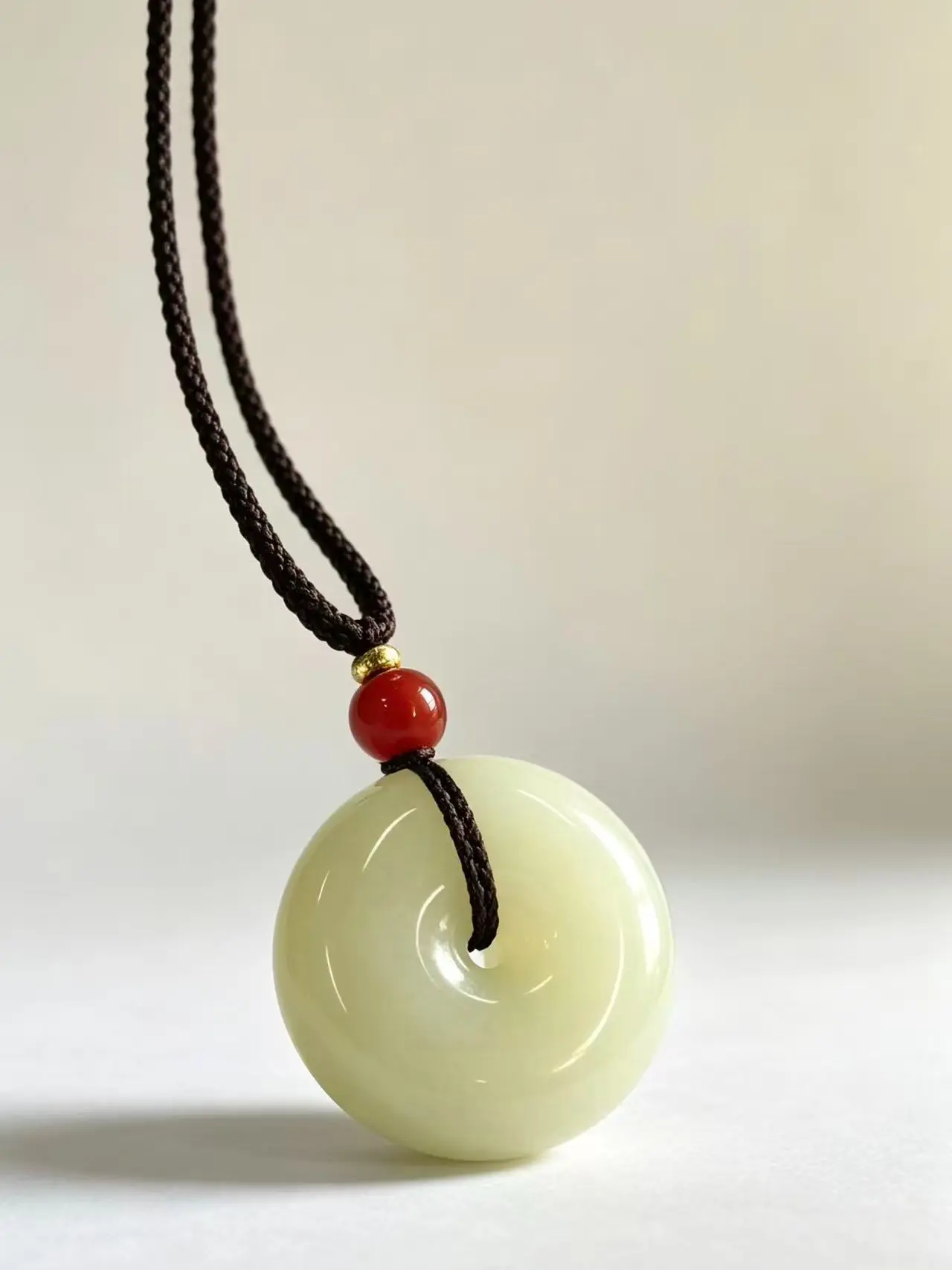 Pure white, translucent, shiny peace charm—smoothly rounded and polished—versatile for both men and women