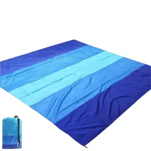 outdoor camping and beach mat is crafted from durable nylon material offering both sand proof and waterproof capabilities Thanks to its compact foldable design it is not only lightweight and easy to clean but also comes complete with ground stakes