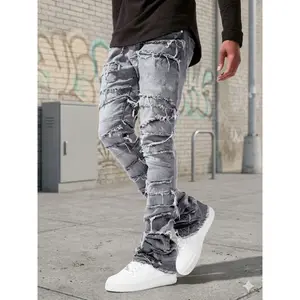 BIGWIG Men's Designer Grey Jeans: Crafted from premium stretch fabric, featuring a relaxed wide-leg silhouette, raw-edge hems, and an intricate distressed finish with crisscross detailing, all complemented by a slimming paneled design