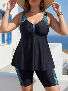 A stylish and comfortable plus-size women's tankini set featuring a black-to-teal gradient marble print and a flattering V-neckline. This Hawaiian-style two-piece swimsuit—complete with a skirted bottom—is the perfect choice for island festivities and bea