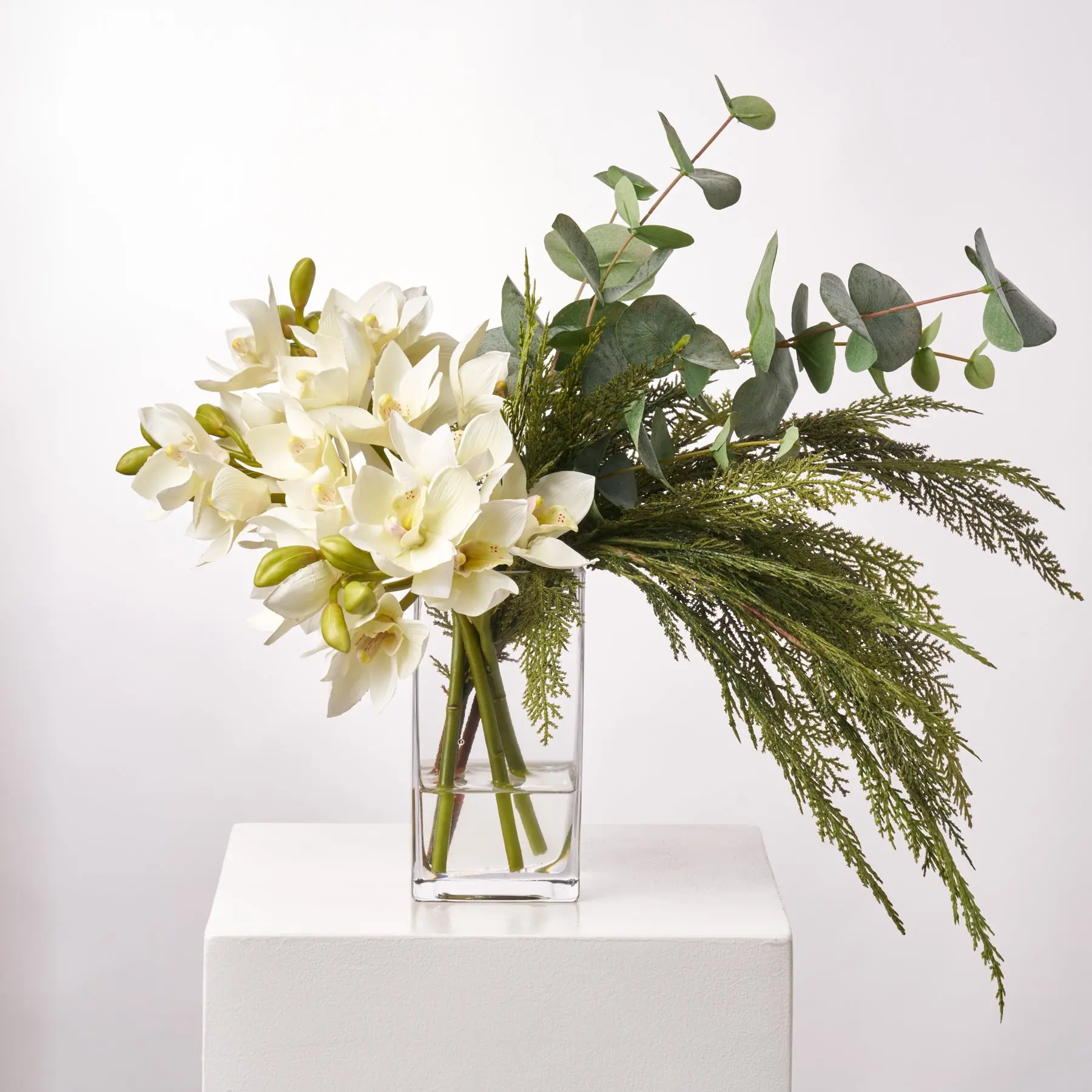 Handcrafted in Ohio Cream Cymbidium Orchid Floral Centerpiece - 20" l x 16" w x 16" h Glass Water Illusion Arrangement with Real-Touch Cedar, Botanical Eucalyptus for Christmas Home Decor