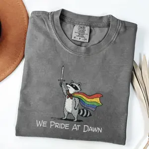 Raccoon Pride T-Shirt, We Pride At Dawn Shirt, Pride Flag Shirt, Pride Gift, Pride Month, Rainbow Flag Graphic Tee