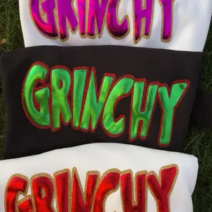 Woman’s Grinchy  puff metallic vinyl outlined with  glitter, on a gildan  sweatshirt 3 color options (red, pink, green)