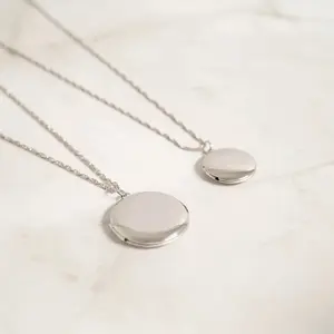 Steel Bonds. Cable Chain paired with engrevable locket. Tarnish and water resistant suitable for everyday wear! 18k gold PVD and stainless steel.