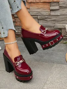 A pair of Women's Platform Block Heel Loafers, Patent Leather Upper, Chunky Studded Lug Sole, Rhinestone Buckle Accent, Edgy Platform Shoes, High Heel Loafers for Parties, Night Out, Street Style, Bold Footwear, Slip-On Design, Trendy Heeled Loafers