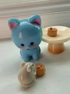 miniature set of cat, mouse with table and two cakes