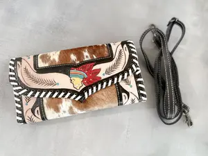 Feathered Indians | Handcrafted Cowhide + Hand Tooled Leather Clutch with Strap