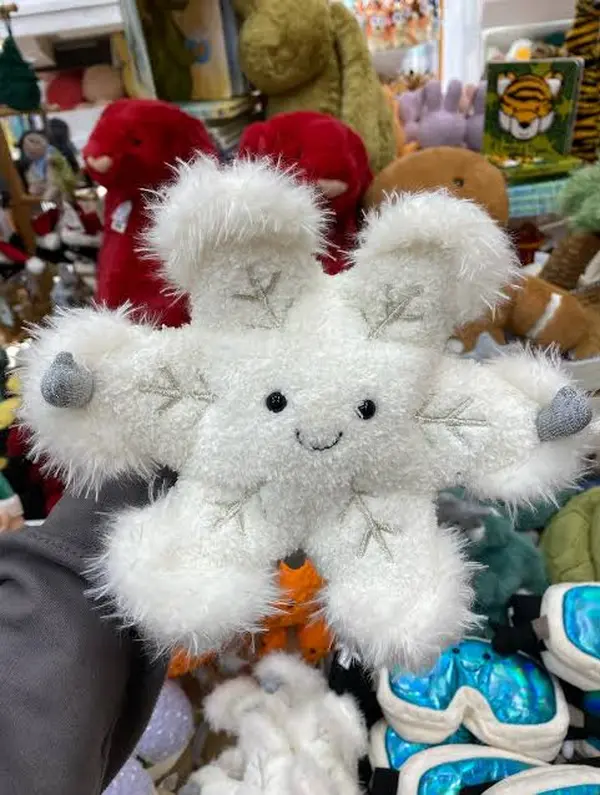 The Amuseables Snowflake is a popular choice for decoration, featuring soft white fur, sparkly mittens, and an adorable smiling face.