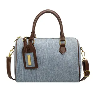 Women's Denim Cylindrical Boston Bag with Brown Leather Handles, Small Round Barrel Shoulder Crossbody Purse with Gold Hardware and Detachable Strap  stylish versatile bag
