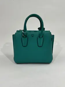 Pre-owned MCM Emerald green grain cowhide leather Crossbody Bags Mini Leather Tote (7.5 × 6.3 × 3.1 inch) Emerald Green Embossed Logo Handbag With Strap