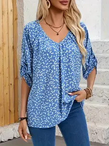 A ladies' blue heart-patterned rolled-sleeved V-neck loose-fitting woven shirt for a sweet, romantic, casual vacation outfit.
