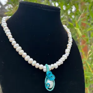 handmade pearl necklace with blue wire wrapped pearl pendant