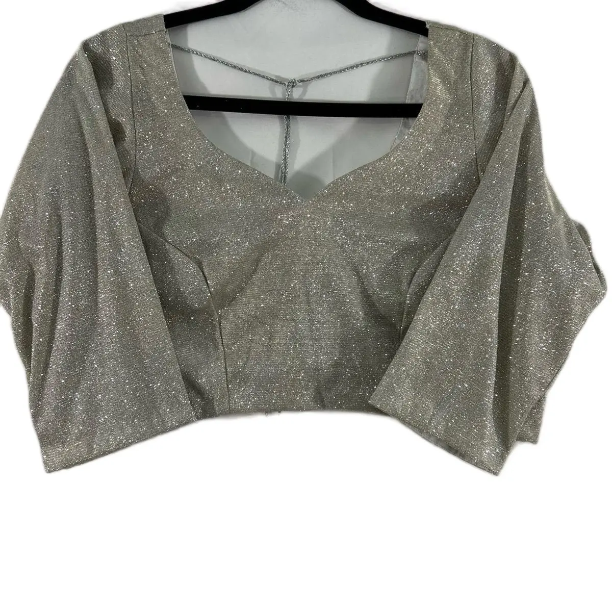 Trendy Women's Silver Shimmer Fitted Blouse with Stylized Deep V Back and Cut Work Design, Matches a variety of Saree and Lehnga Choices.
