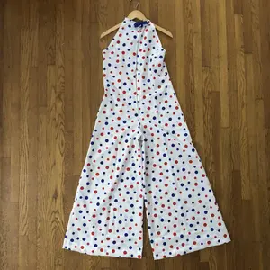 70S INSPIRED WHITE SLEEVELESS HALTER TOP JUMPSUIT WITH RED AND BLUE POLKA DOTS