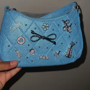 Mini Hobo Bag with Stitch Detail & Pom Pom Charm Blue Zipper Closure Lightweight Casual Fashionable Design