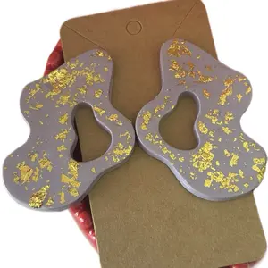 Wavy Polymer Clay Earrings Handmade with Gold Speckles on Gray Background