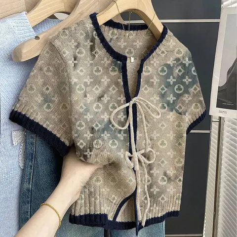 Women's khaki bohemian vacation short-sleeve knit top. Loose round neck, contrast geometric print, front tie and contrast piping. Comfortable and stylish for spring & summer casual wear. Casual Comfy Classy Blouse Shirt Top