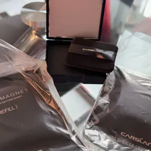 Product Review of CARSLAN Black Magnet Oil Blotting Setting Sheet With Powder More Control Oil Keep Fresh 2 IN 1 Blotting Sheet with Mirror Puff & Recyclable Case 450 Sheets 1 Box 2 Refills from M**y A**o