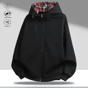 A hooded zip up jacket with a red and black plaid lining inside the hood adds design and vintage vibes. The jacket features a zipper closure and detachable hood, making it stylish and elevating the outfit. There's a small zipper pocket on the chest and re