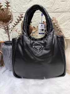 Pre-owned PRADA HOBO Black Leather Handbag with Logo Charm and Adjustable Strap for Everyday Use