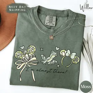 Comfort Colors Retro Southern Lily Princess Shirt, Playful Bayou Magic Mouse Ears Tee, Vintage Botanical Frog Prince Outfit, Trendy Coquette Bow Fairytale Design, Premium Oversized Magical Vacation Gift