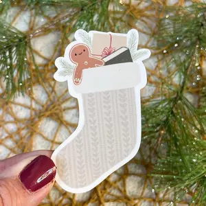 Stocking with gingerbread boy, gifts and a book sticker