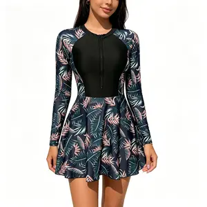 Women's Long-Sleeve Tankini Dress—A black, front-zip sun-protective one-piece swimsuit featuring a flared skirt with a tropical leaf print, perfect for a beach vacation
