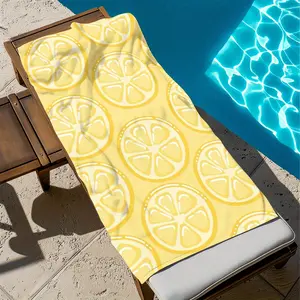 A microfiber beach towel featuring a yellow lemon slice design, perfect for summer enjoyment. It is stylish, absorbent, and made of large-sized quick-drying polyester.
