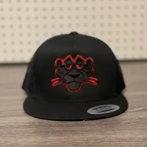 Panther Red Puff Embroidered Trucker Hat.