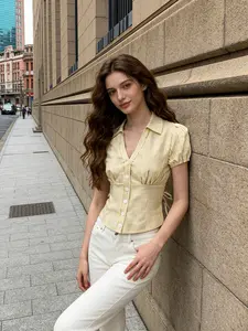 A women's fashionable yellow and white striped bubble sleeve short shirt adds sweetness, with a short silhouette that is proportionate and suitable for commuting to work, shopping, outdoor activities, indoor and outdoor dressing