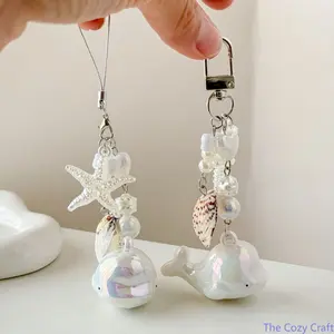 Ocean‑Style Whale & Starfish Bag Charm Keychain, Natural Shell Phone & Kuka Chain, Trendy Aesthetic CCD Camera Decor Accessory, Dainty Beach‑Themed Hanging Ornament, Stylish Coastal Decor for Handbags, Backpacks, Daily Styling and Summer Outfit Matching o