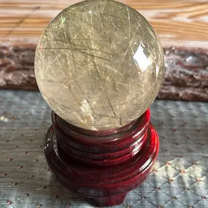 Clear quartz with green rutile sphere